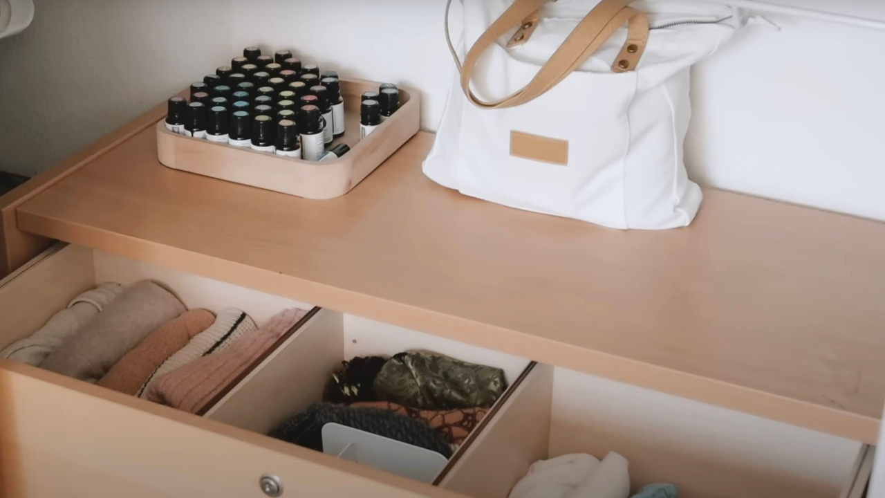 An open dresser drawer with neatly folded, sorted clothing