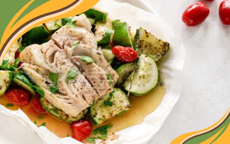 Baked white fish served with zucchini, cherry tomatoes, and fresh herbs in a light, flavorful sauce.