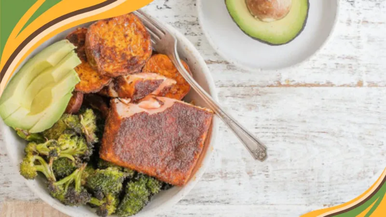 A nourishing bowl featuring BBQ-spiced salmon, roasted sweet potatoes, and broccoli, topped with fresh avocado slices. The image highlights a wholesome, balanced meal that supports healthy weight loss through real, satisfying food. GRWL brand colors curve along the side, symbolizing warmth, energy, and sustainable nourishment.