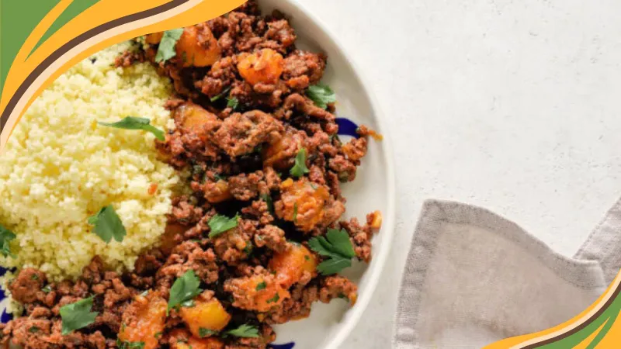 A vibrant plate of spiced ground beef with potatoes and fluffy couscous, garnished with fresh parsley.