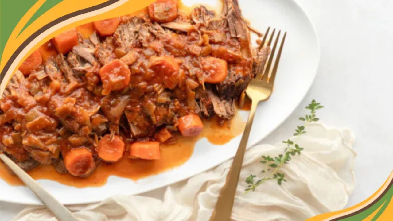 Tender sliced pot roast topped with savory tomato and carrot gravy, served on a white platter with gold utensils.