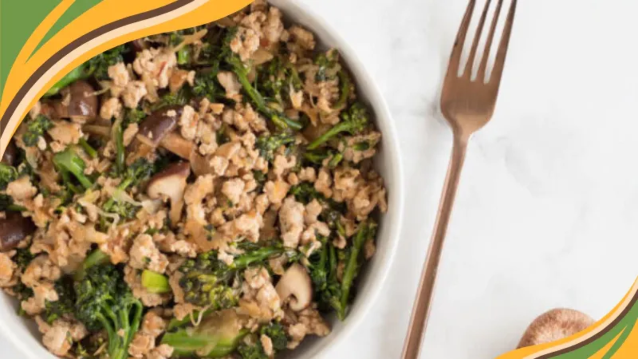 A nourishing bowl of sweet chili ground turkey with broccoli and mushrooms, served beside a bronze fork on a light marble surface. A warm, colorful swoosh in GRWL’s brand colors curves in the corner, reflecting a compassionate approach to real food and sustainable weight loss.