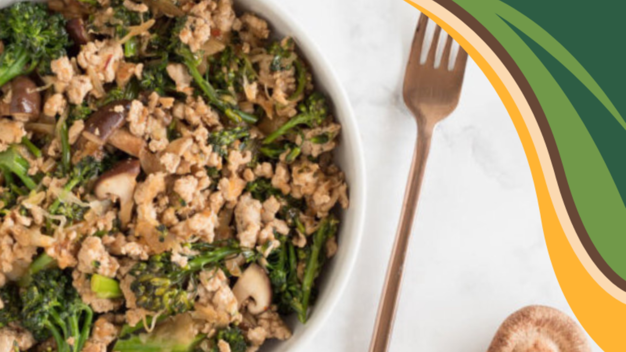 A nourishing bowl of sweet chili ground turkey with broccoli and mushrooms, served beside a bronze fork on a light marble surface. A warm, colorful swoosh in GRWL’s brand colors curves in the corner, reflecting a compassionate approach to real food and sustainable weight loss.