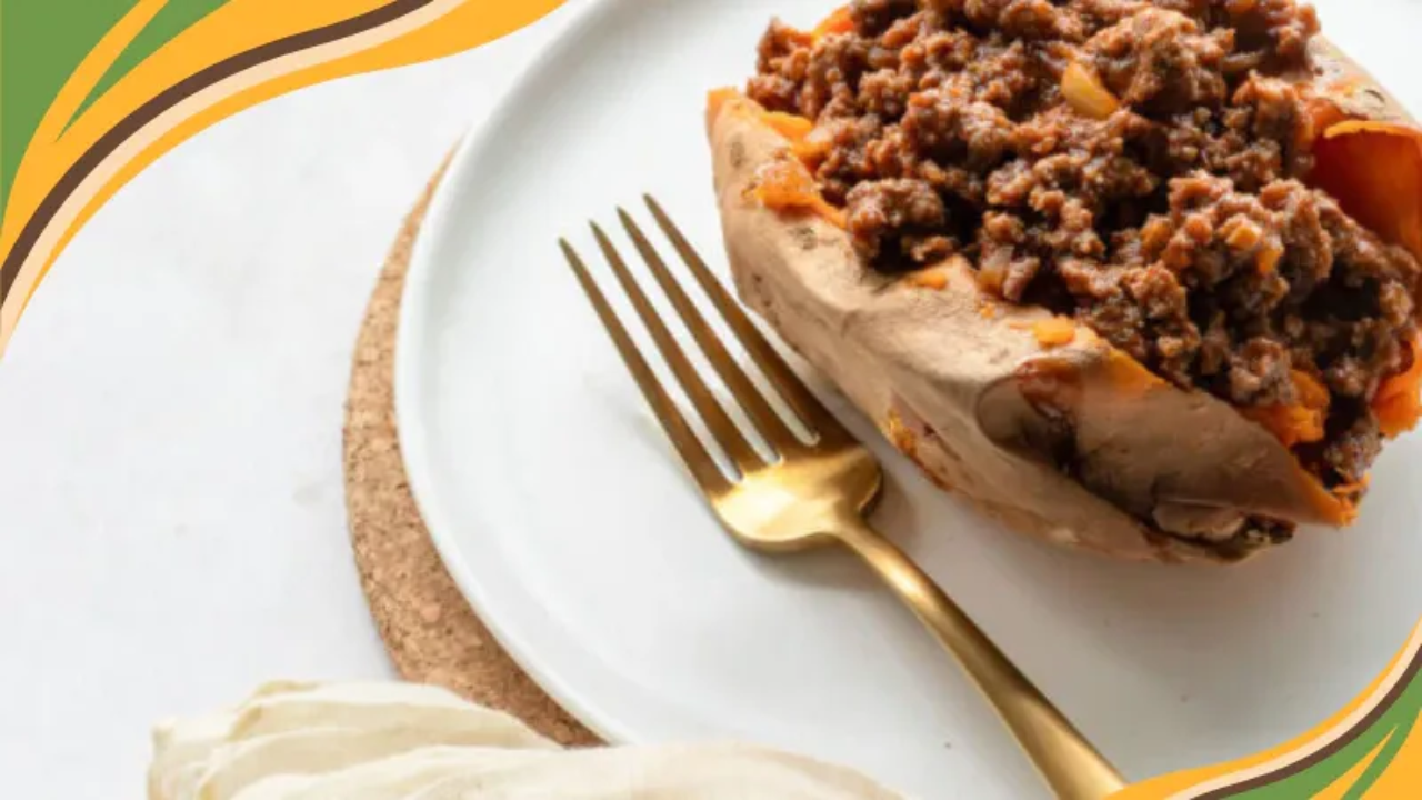 A warm, home-cooked plate of sloppy joe-stuffed sweet potatoes, topped with a savory meat and tomato filling. The golden baked sweet potato contrasts with the hearty sauce, making this dish both nourishing and comforting. A perfect example of real food that feels indulgent yet supports compassionate weight loss.