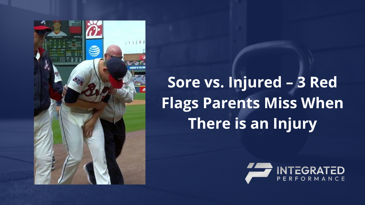 A concerned father talking to his son in a baseball dugout about his arm pain.