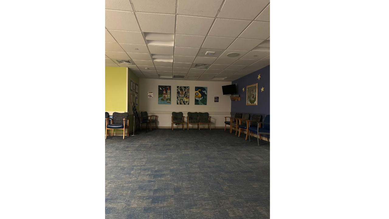 Quiet hospital waiting area with empty chairs
