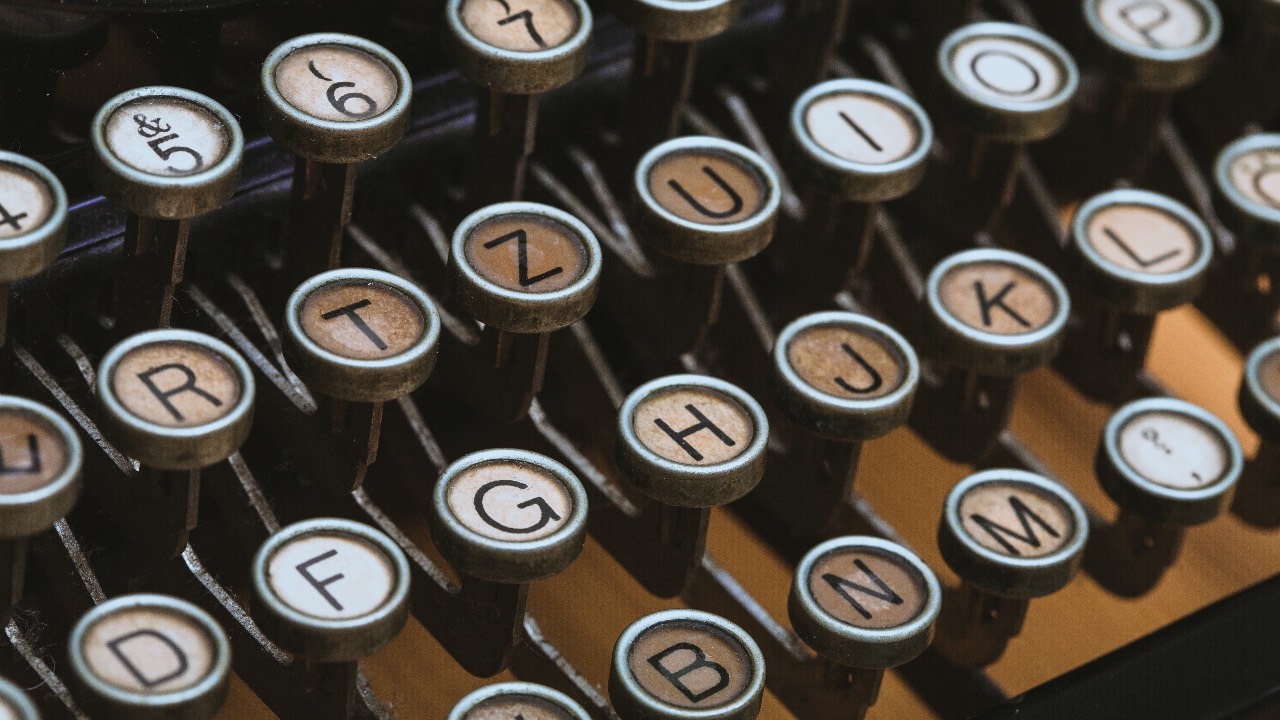 Close-up of vintage typewriter keys, symbolizing the importance of precision in coding, analogous to 'How to improve Python code with type hinting' for better software development.