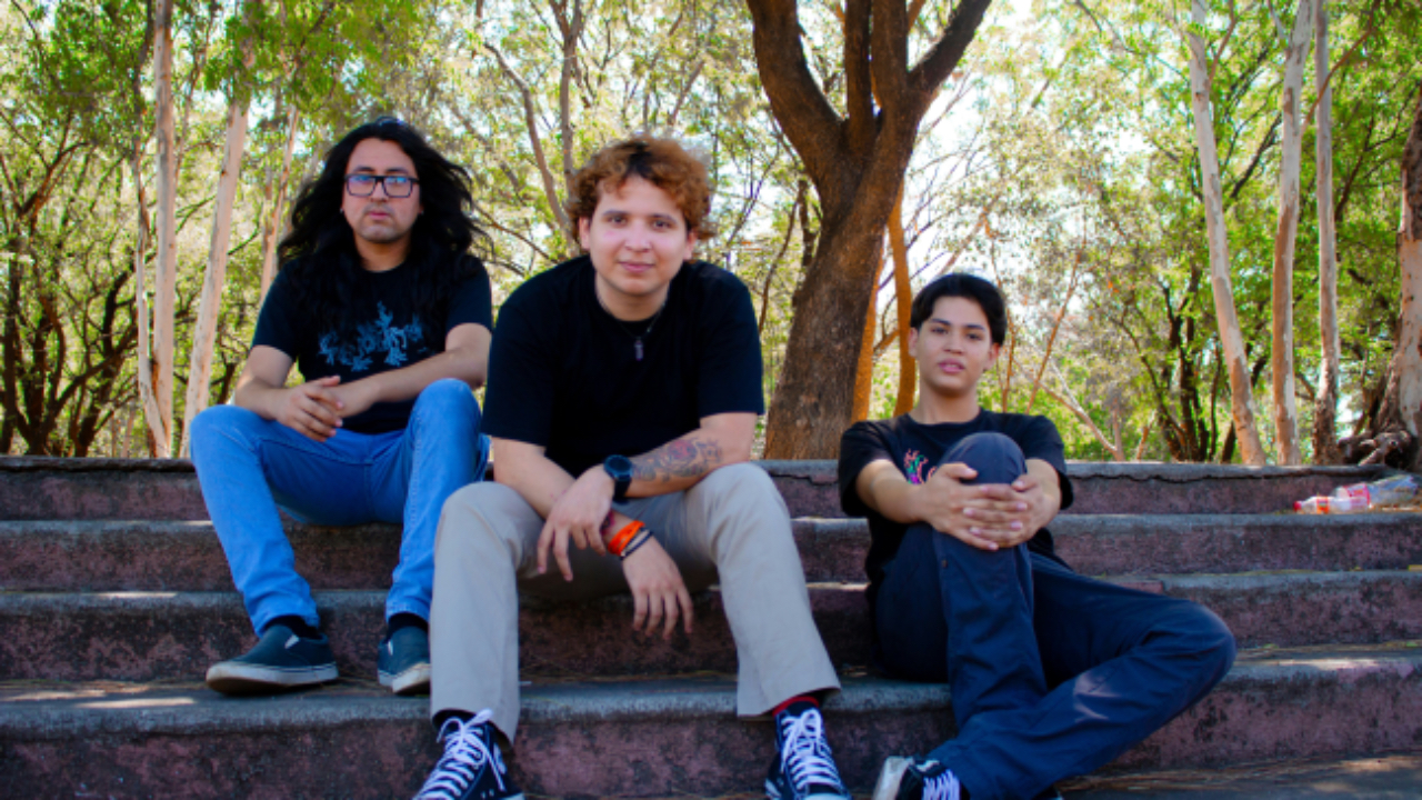 Three young adults sitting together on outdoor steps, relaxed and confident
