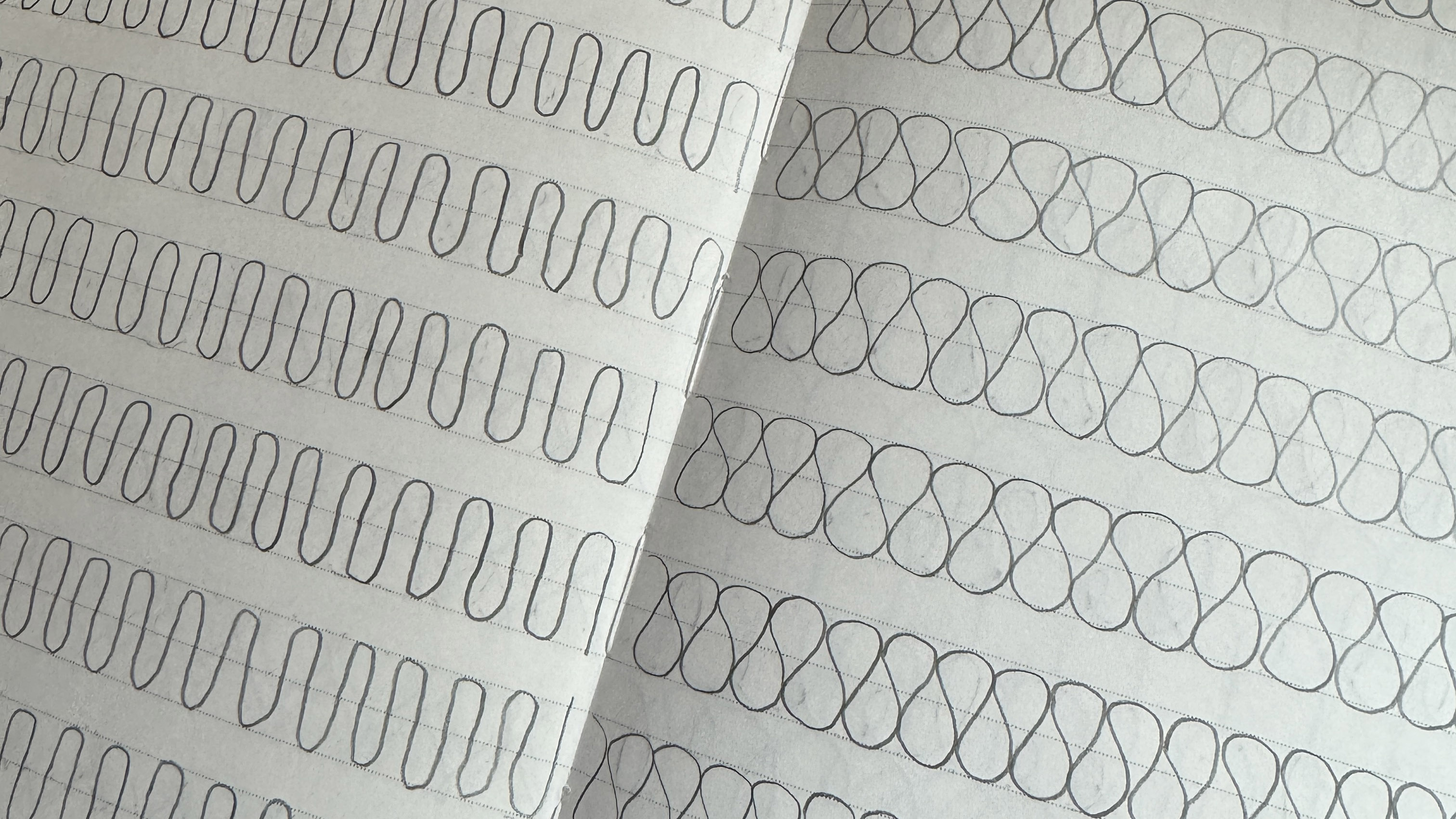 an open doodle book filled with switchback and ribbon candy free motion quilting designs drawn in pen