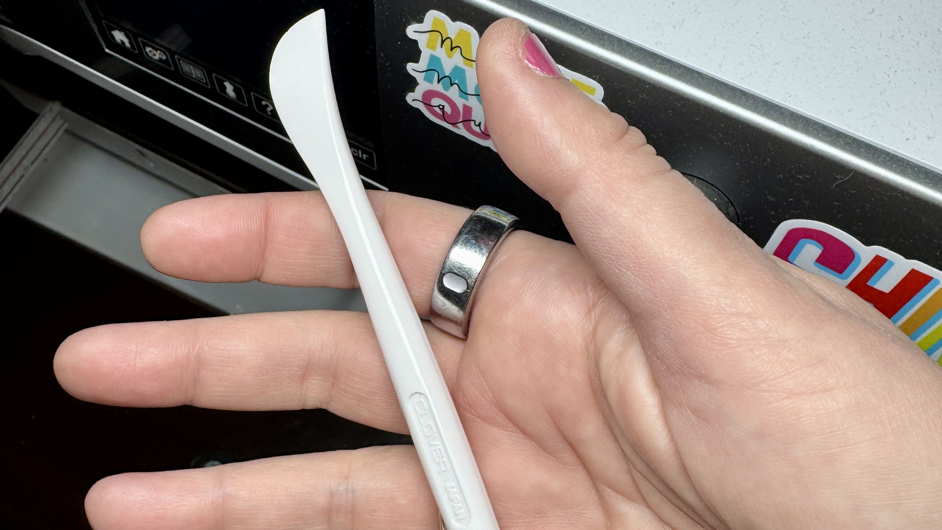 hand holding a hera marker. a hera marker is an ink-free way to mark quilts