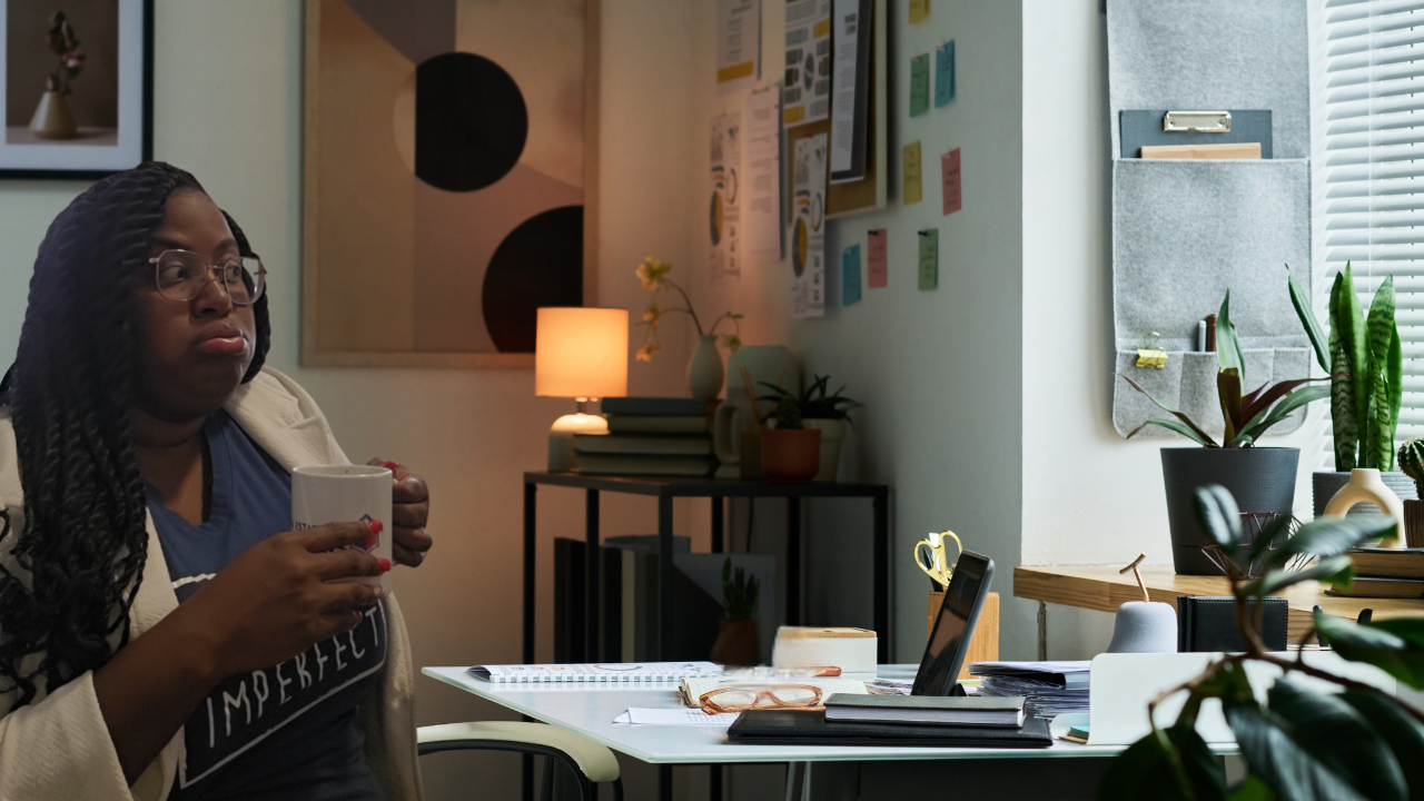 Josie pouting while sipping coffee at a work desk