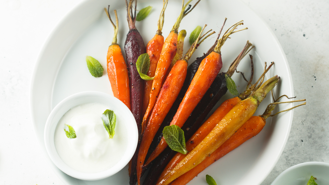 Plate with colorful roasted carrots paired with a ranch dip