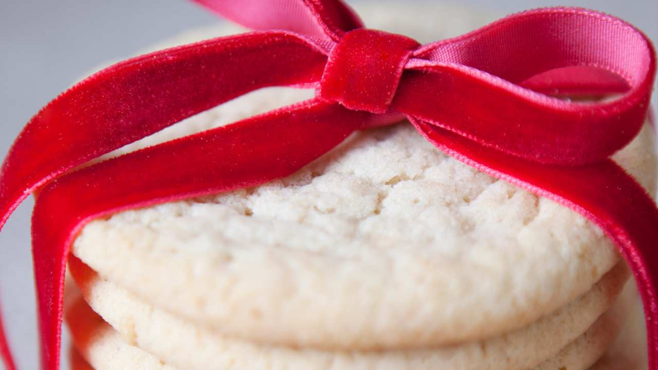 stack of sugar cookies wrapped in a red velvet bow