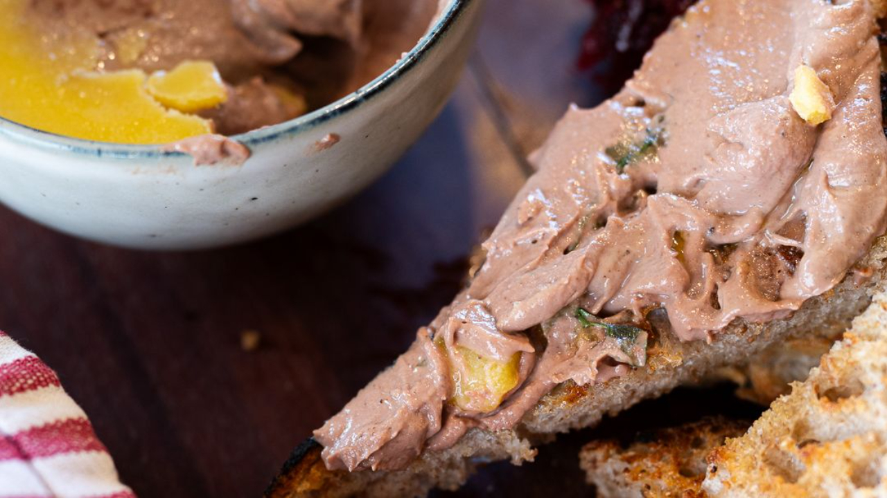 chicken liver parfait in small ramekins with toasted sourdough on a wooden board
