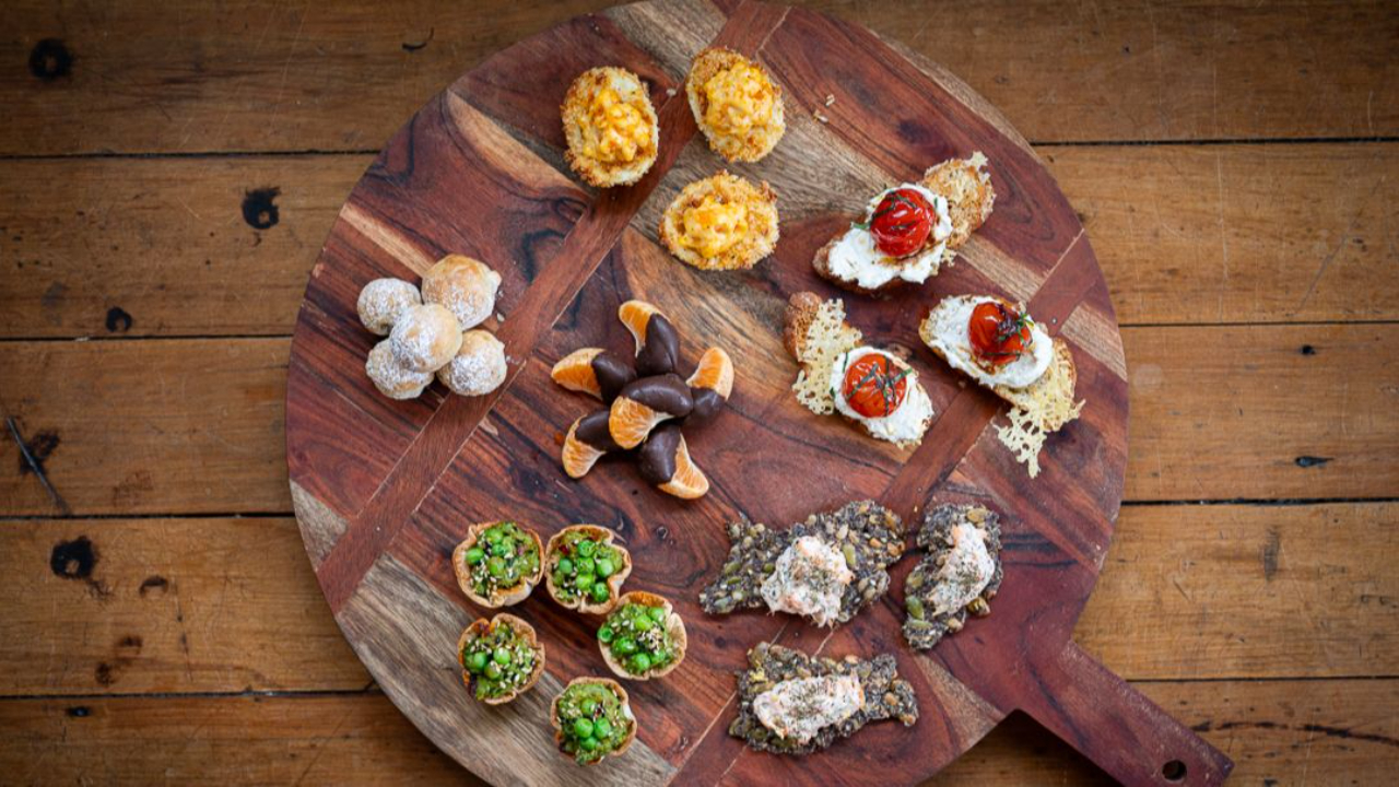 colourful canape platter with salmon rillettes crostini devilled eggs and sweet treats for new years party