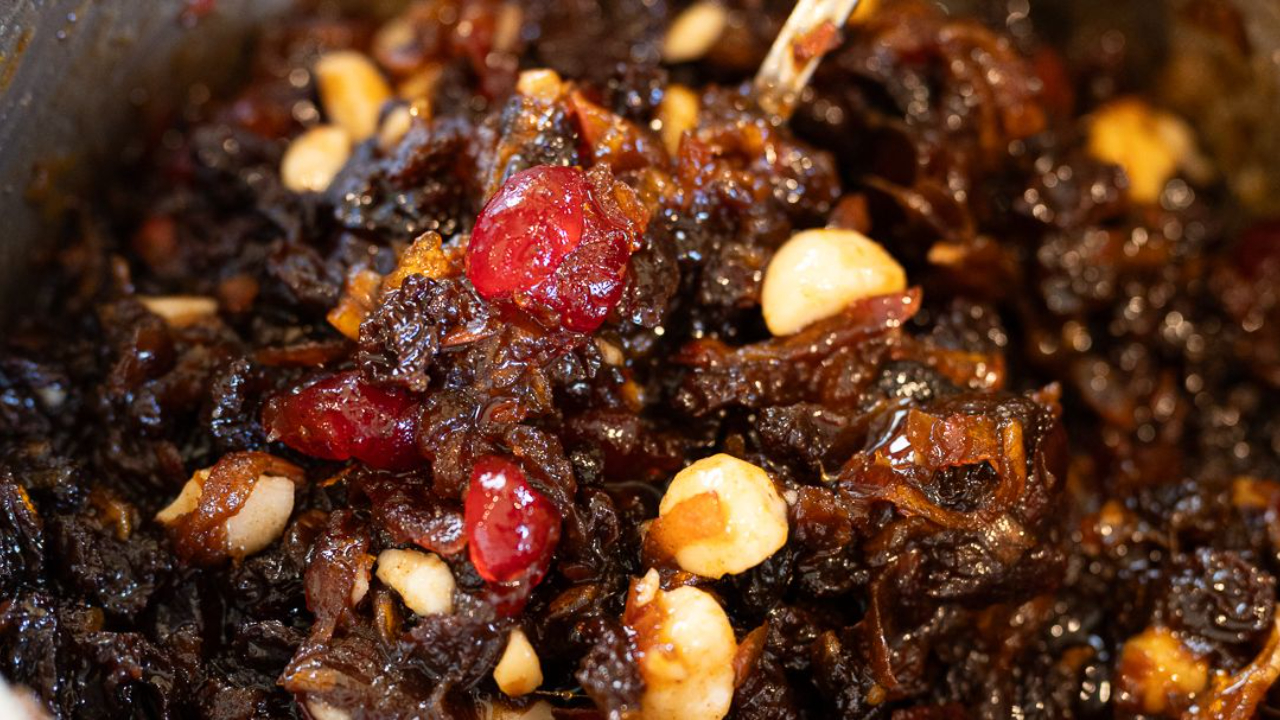 A pan of homemade Christmas mincemeat with fruit, nuts, and citrus zest.