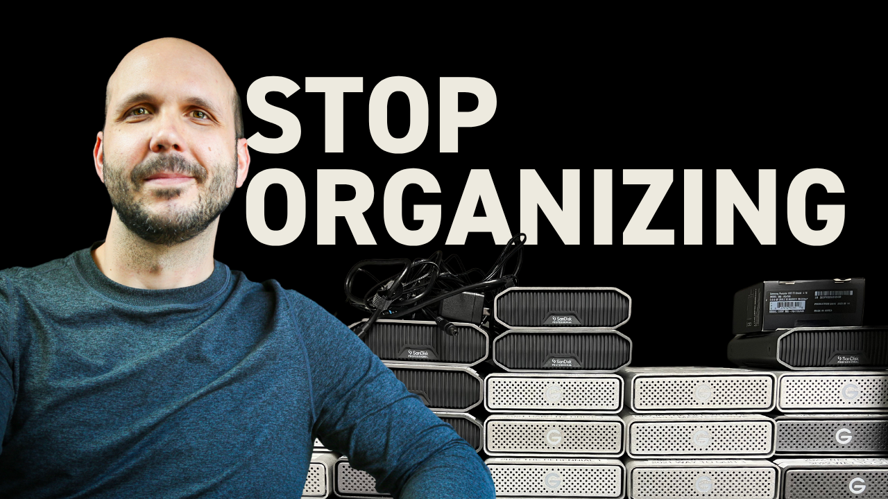 Pro video editor sitting in front of a pile of old hard drives