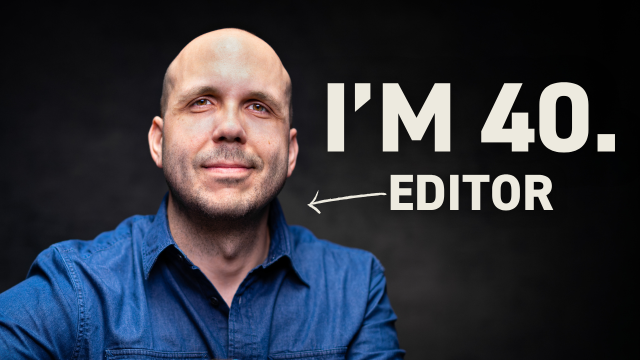 Professional video editor working at computer workstation with multiple monitors showing editing timeline