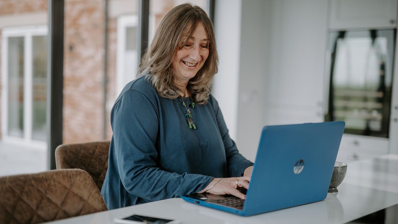 Elizabeth James, The Baby Class Expert, working at her desk explaining the real costs of starting independent baby classes.
