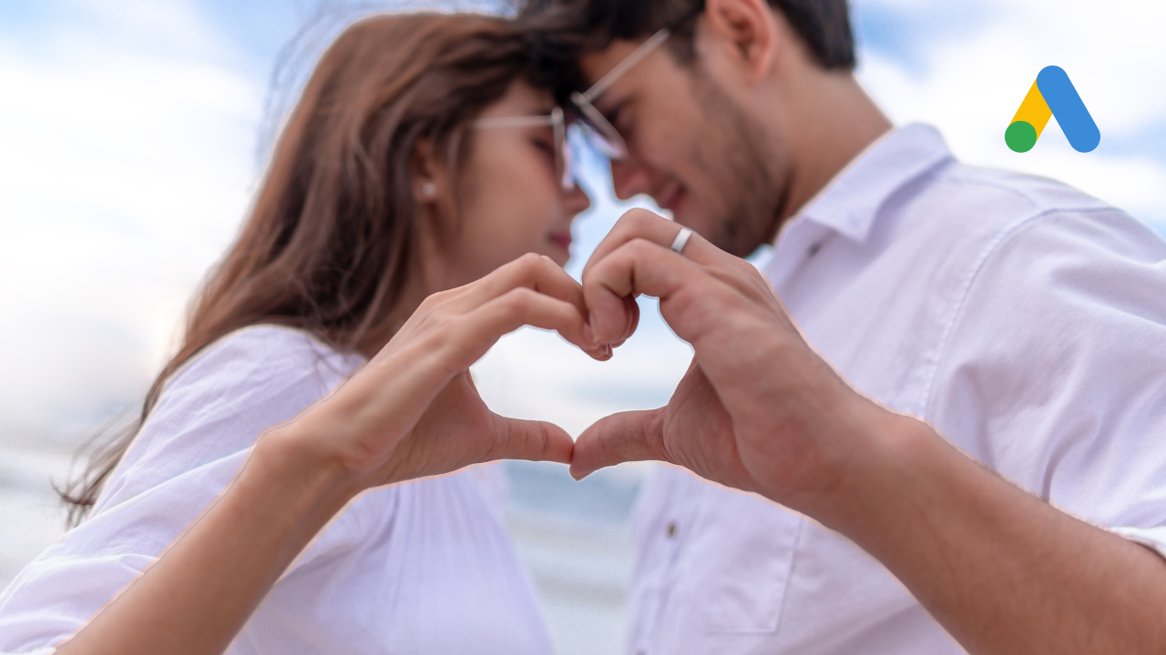 a couple holding their hands up together to make a heart shape