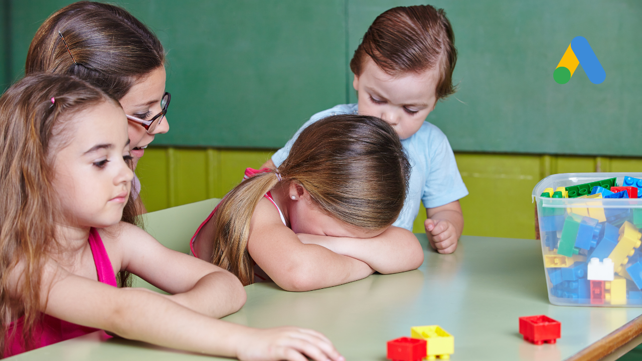a mom with three kids, and one of the kids has her head down as if she's upset