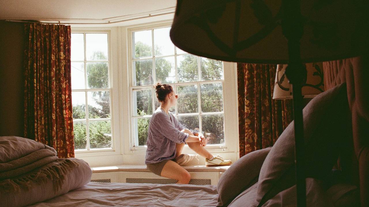 woman practicing somatic slow living looking out the window