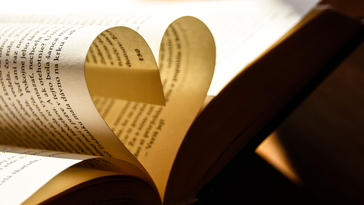 Open book with heart-shaped pages representing grantor appreciation through thank-you letters, public recognition, and detailed impact reports.