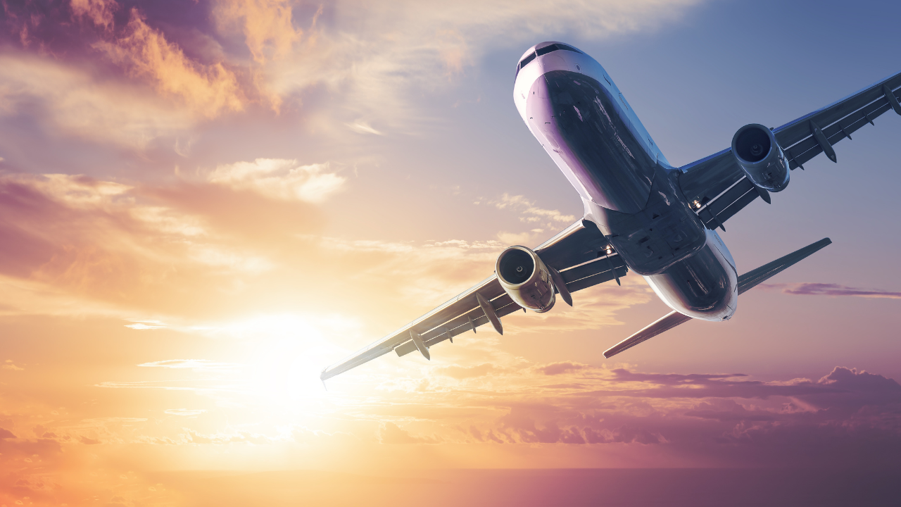 Commercial airplane flying into a golden sunset, symbolizing the personal journeys, dedication, and sacrifices made to restore Jefferson Davis’s U.S. citizenship.