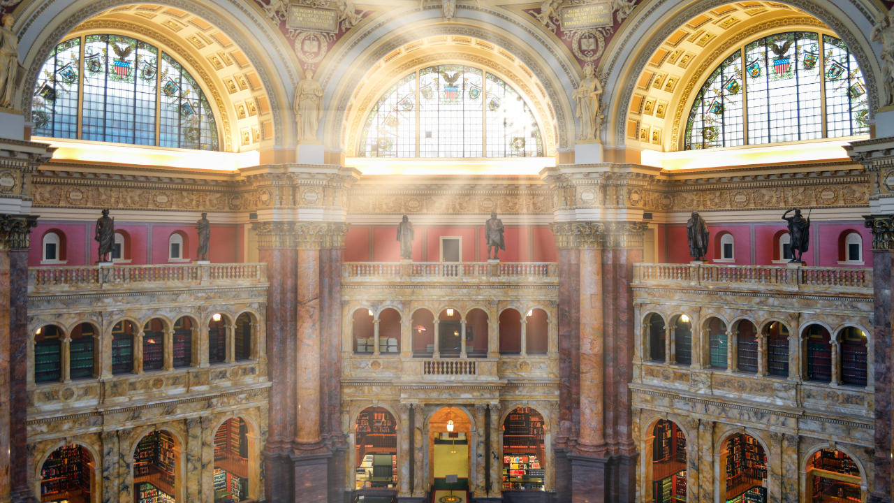 Sunlight streams into the ornate reading room of the Library of Congress, symbolizing unity and bipartisan effort in restoring Jefferson Davis’s U.S. citizenship.