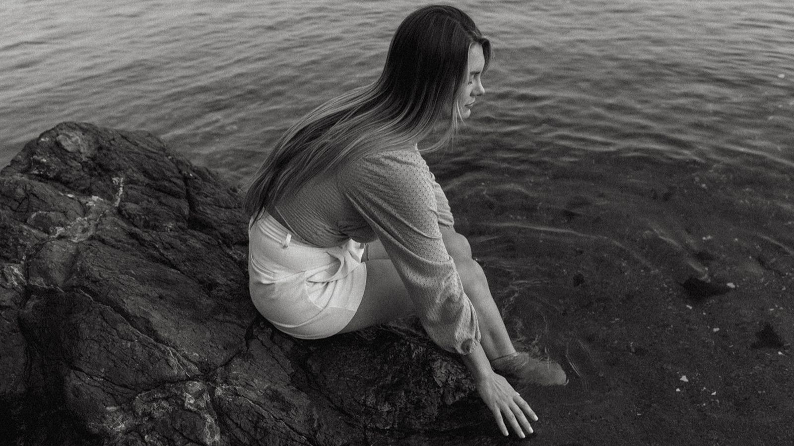 Natasha is sitting by the beach