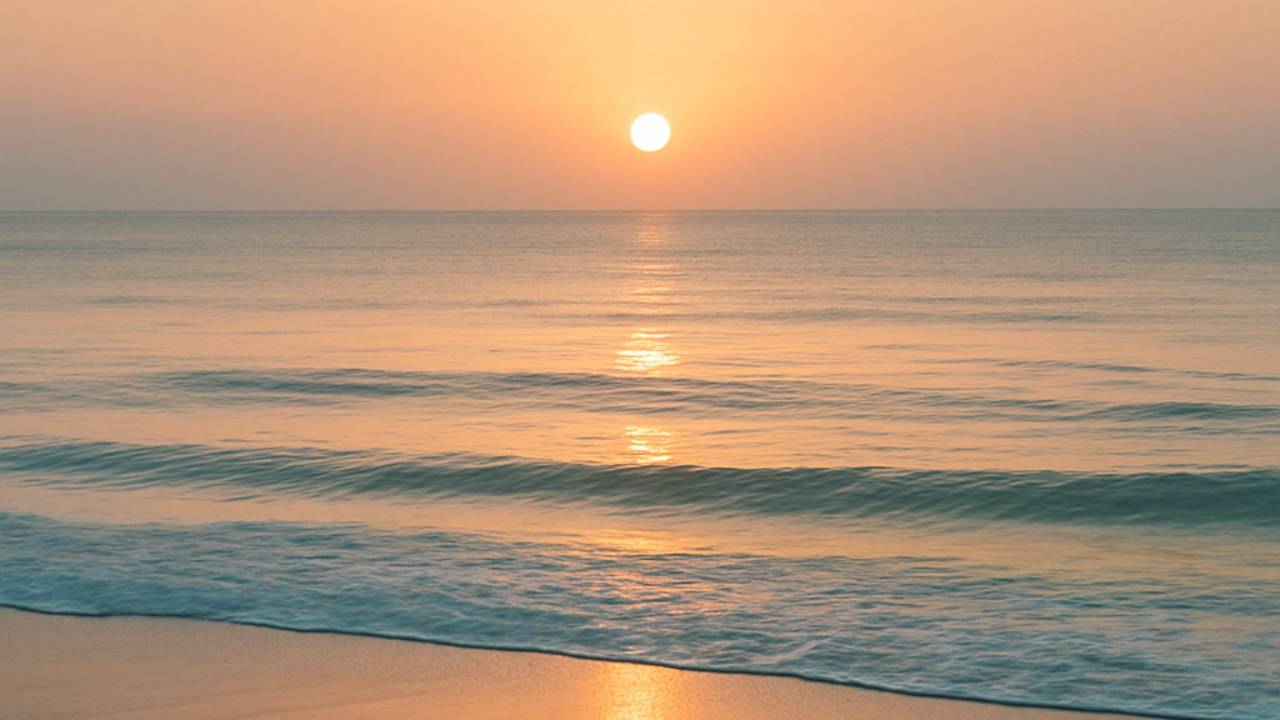 Calming image of a sunset over a beach.