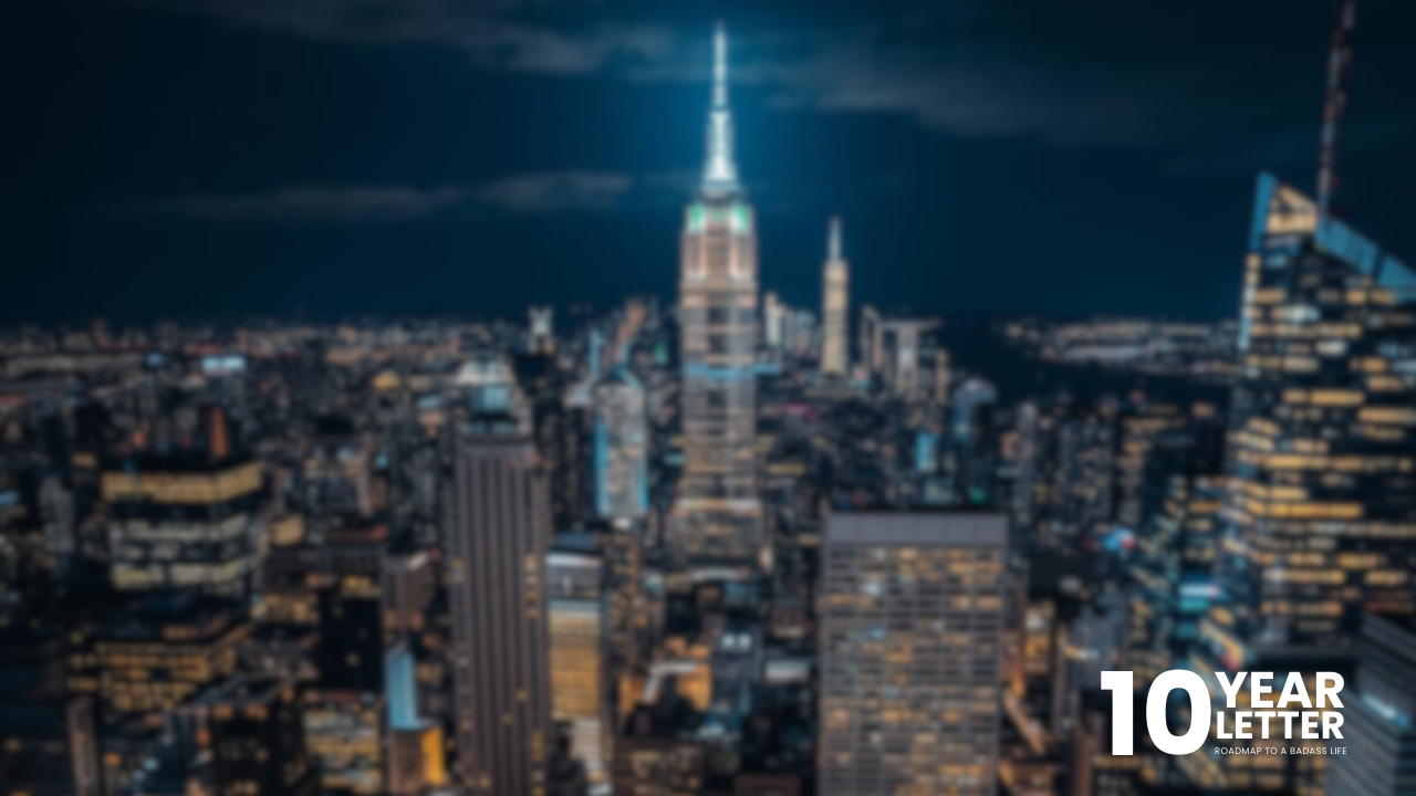 Softly blurred city buildings and lights at night, creating a quiet, contemplative atmosphere.