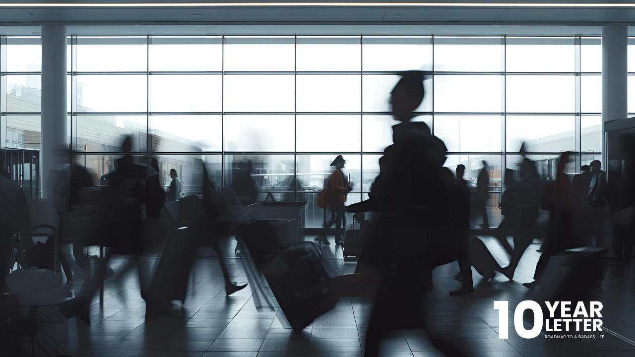 A lone traveler stands still in a busy airport while people rush past in blurred motion, symbolizing the feeling of moving fast in life without real direction or clarity.