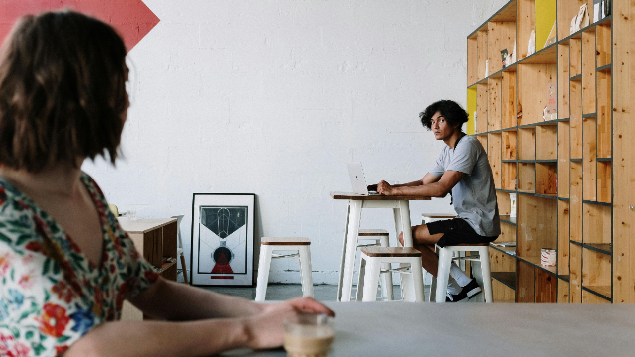 two people sitting apart in the same room, one trying to engage while the other is distracted, reflecting what it feels like when someone won’t listen
