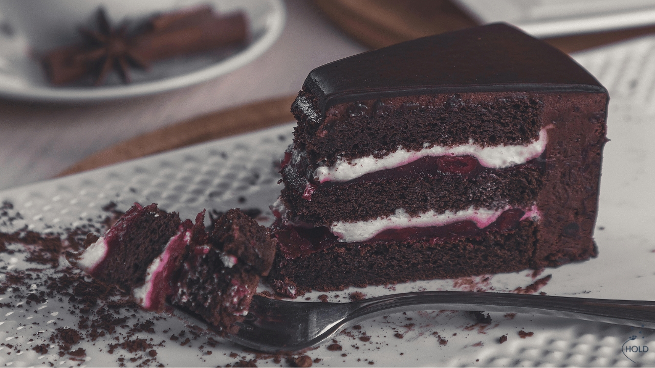 A half eaten dessert sitting on a table, without the other person to decide who gets the last bite