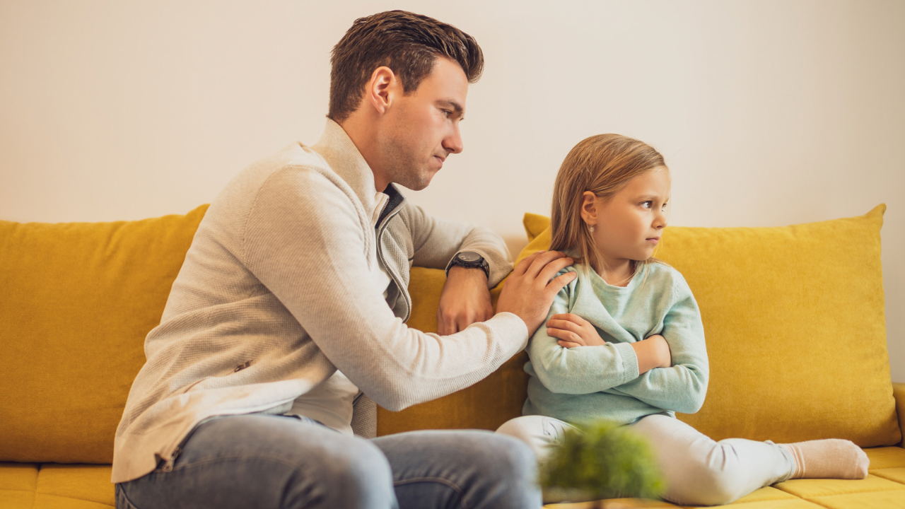 Parent gently reconnecting with upset child after a difficult moment at home