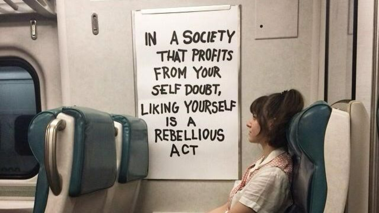 A bold quote about radical self-love and reclaiming your worth in a world that profits from insecurity.