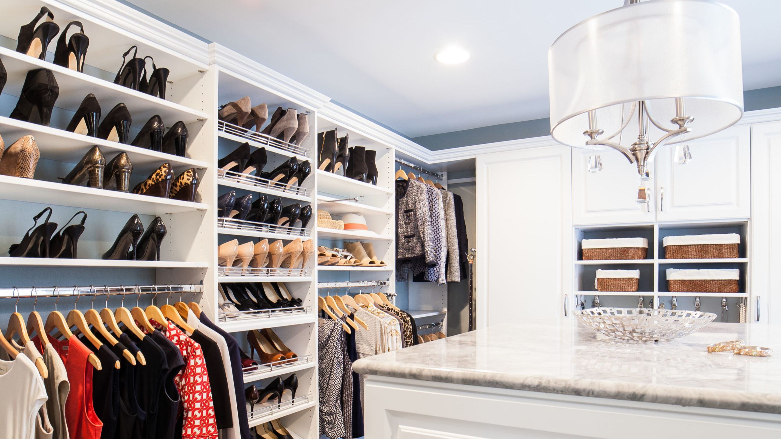 An image of an organized and well planned closet that feels calm to enter and easy to get dressed from.