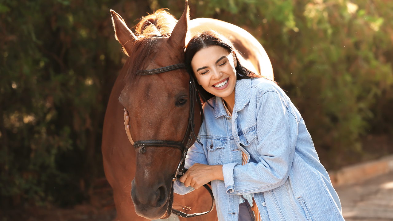 Horse and woman smiling in the sun