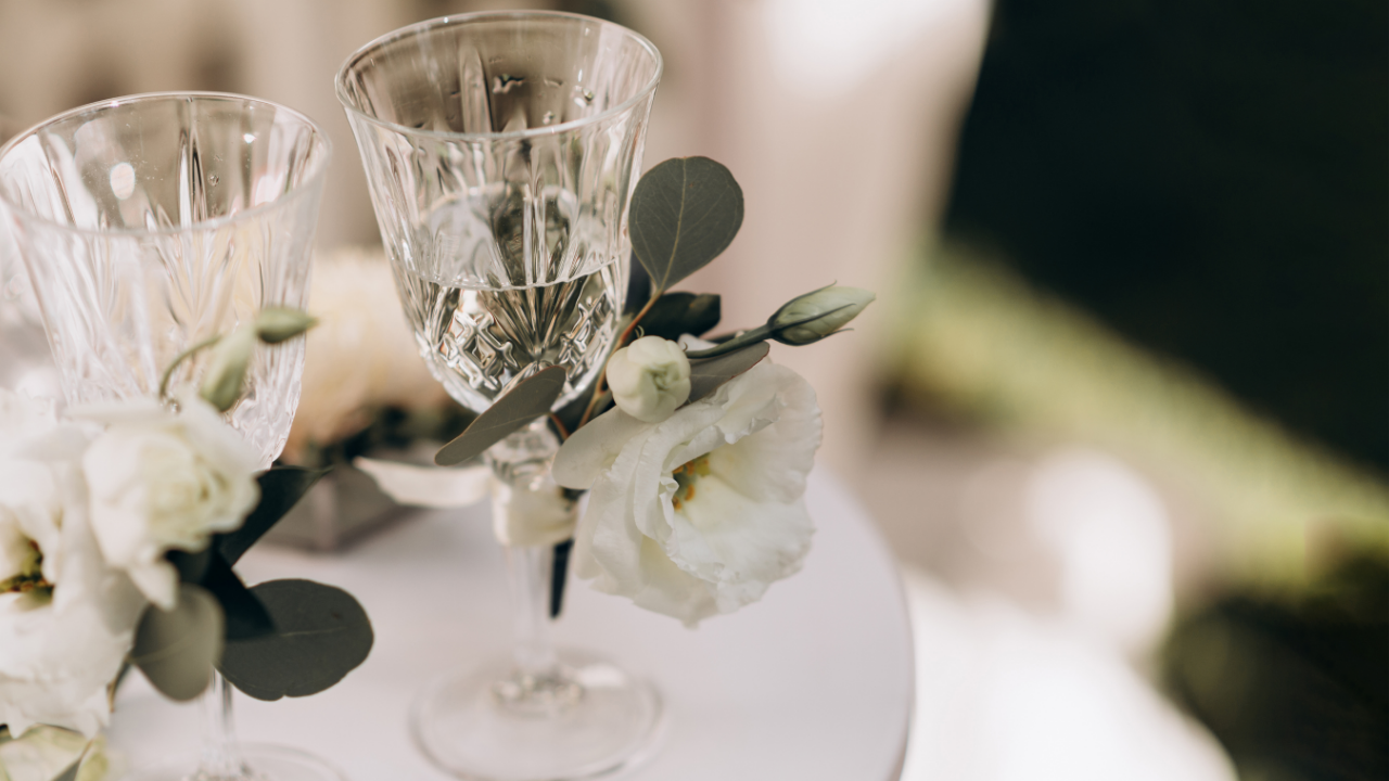 Elegant wedding glasses and floral arrangement symbolizing a celebratory toast at an LDS wedding reception.