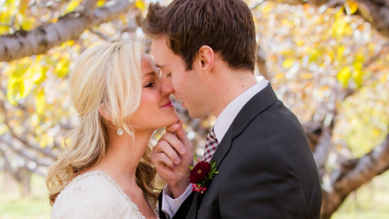 Bride and groom sharing a tender moment outdoors, symbolizing grace, kindness, and thoughtful choices for LDS wedding planning and etiquette, after using the graceful do's and dont's.