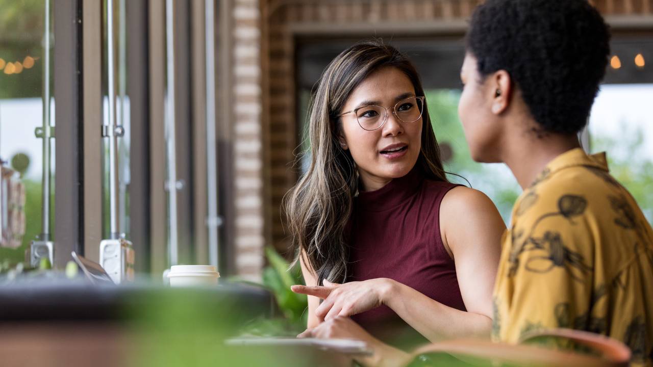Two female employees having a conversation