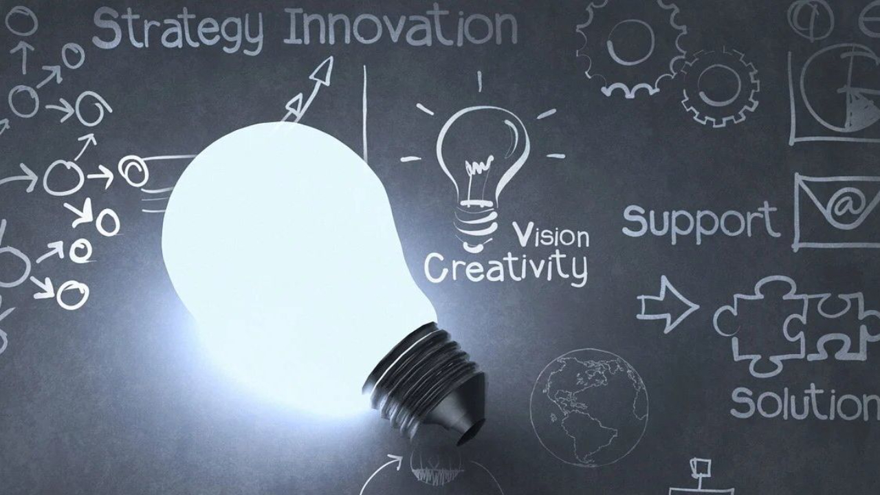 A lightbulb on a board with words that read “strategy innovation”, “support”, “vision”, “creativity”, and “solution”