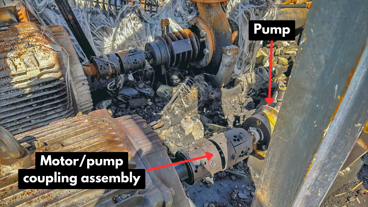 Motor and pump coupling assembly. Parts of the failed pipe expansion joint can be seen in the background.