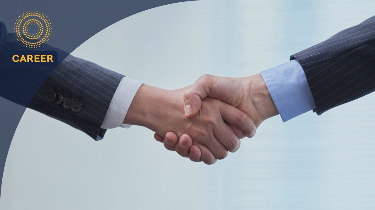 Two professionals shaking hands after a successful job offer negotiation.