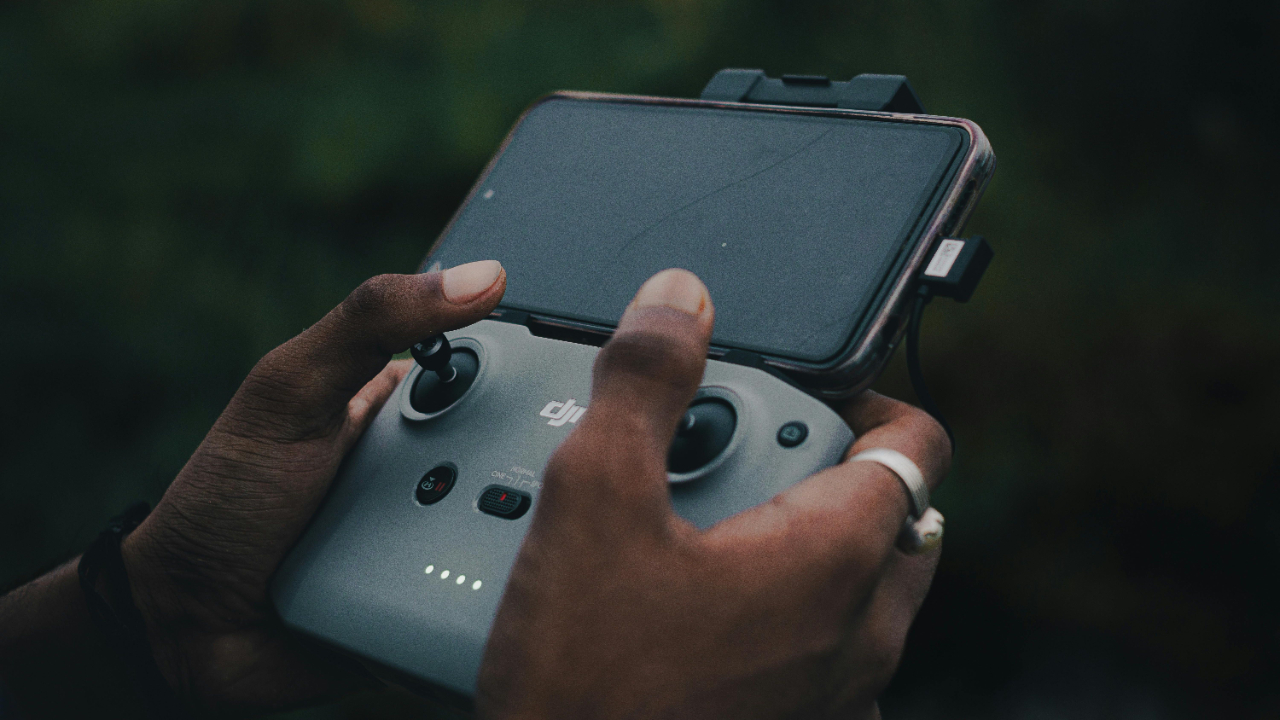Man holding a remote control device symbolizing control and emotional regulation in marriage under pressure