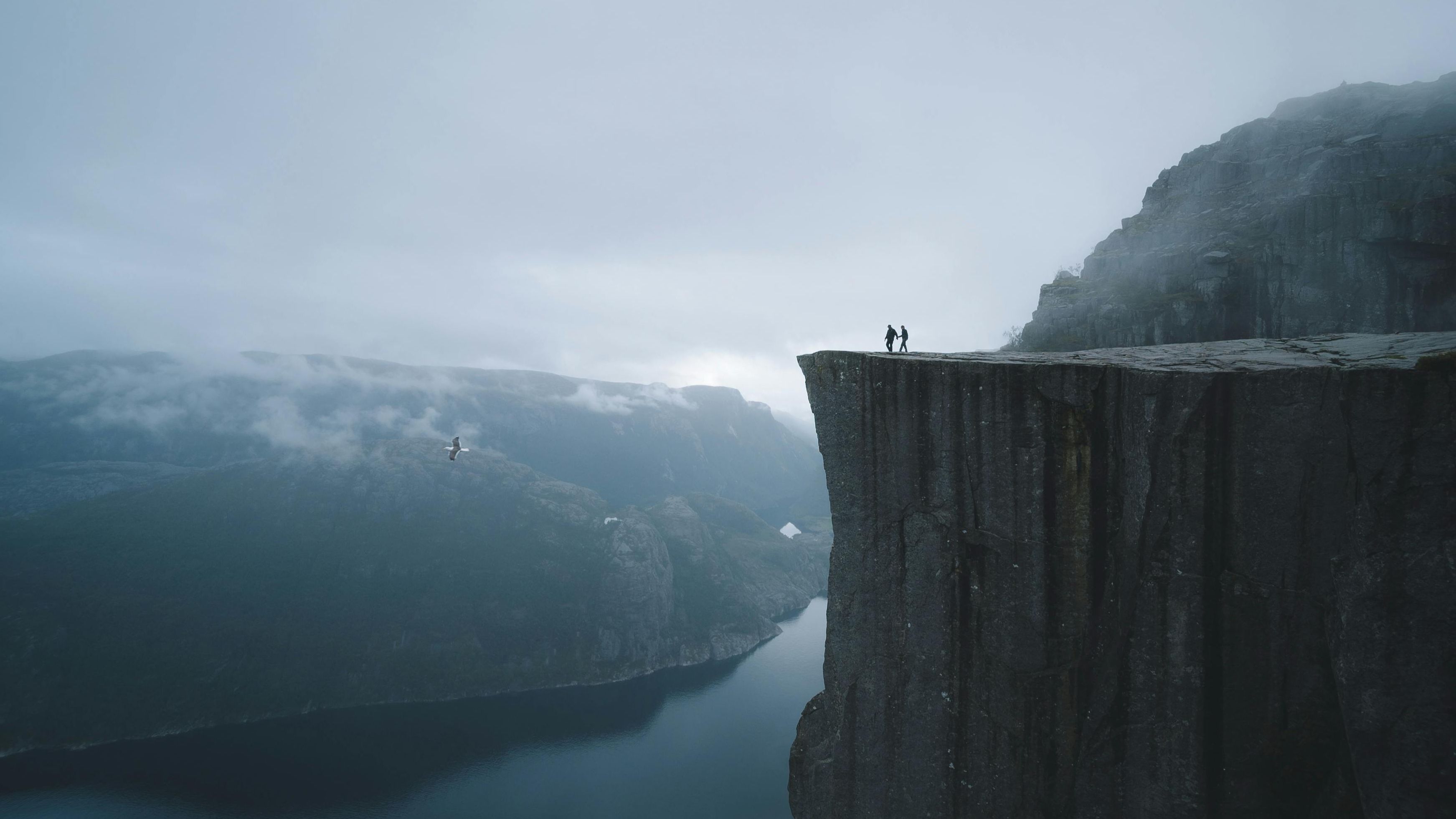 Two people walking along the edge of a perilous cliff, symbolizing the way a husband can take the lead and bring a marriage back from the brink.