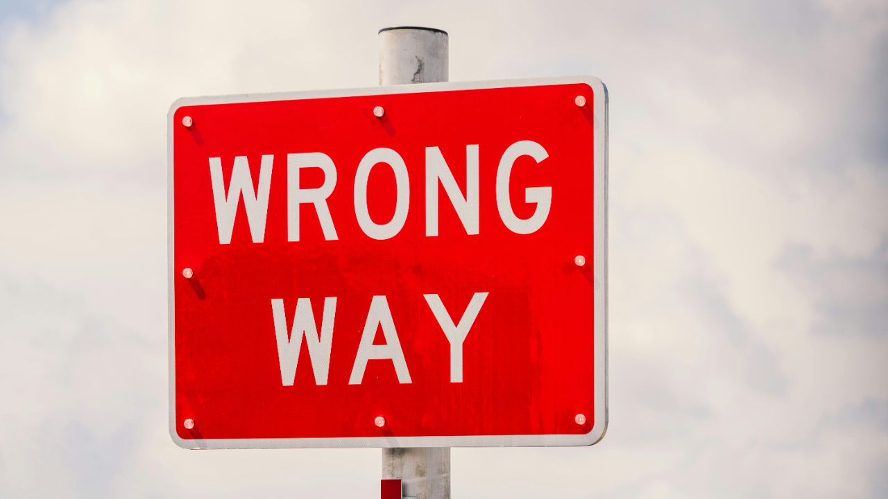 A wrong way sign, alluding to the way in which many men will incorrectly go about recovering after making a mistake.