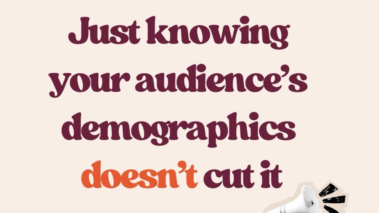 Neutral beige graphic with bold burgundy and orange text that reads: “Just knowing your audience’s demographics doesn’t cut it anymore.” Includes small megaphone and arrow illustrations and Brandakin Social Media branding. The graphic supports a post about moving from demographic targeting to psychographic-driven messaging for better content conversion.