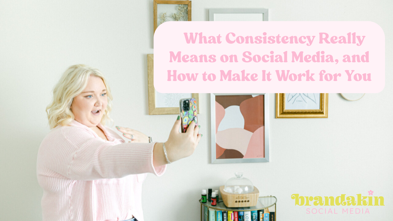 Woman in light pink sweater recording a selfie-style video in a styled office space with layered wall art; overlay text reads "What Consistency Really Means on Social Media, and How to Make It Work for You" with the Brandakin Social Media logo in the corner.